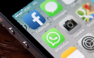 The Facebook and WhatsApp app icons are displayed on an iPhone 