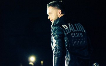 Finn Balor wearing his Balor Club jacket in an NXT event.