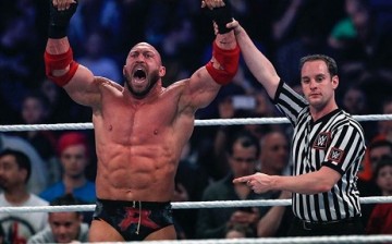 Ryback celebrates a win with a WWE referee.