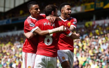 Manchester United winger Juan Mata (middle) celebrates his goal against Norwich City with teammates Jesse Lingard (L) and Memphis Depay.