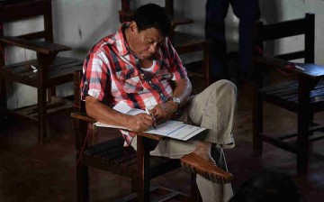 Presidential candidate Rodrigo Duterte casting his vote inside a polling precinct on May 9, 2016 in Davao city, Philippines.    