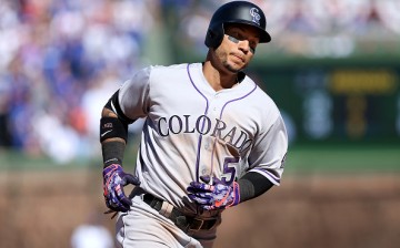 Carlos Gonzalez of the Colorado Rockies is rounding the bases after hitting a home run.