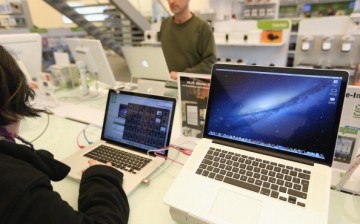 Apple MacBook Pro computers with Retina displays stand at a table at a Gravis Apple retailer on Nov. 6, 2012 in Berlin, Germany. 