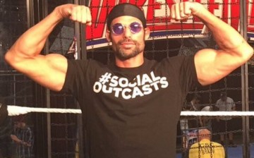 WWE Superstar Adam Rose poses with his Social Outcast shirt.