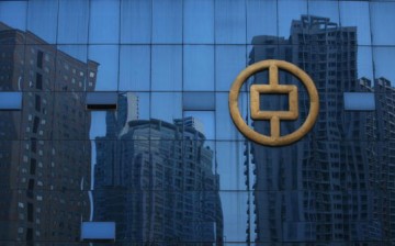 Buildings under construction are reflected on glass at the People's Bank of China office building on Sept. 29, 2007 in Chongqing, China.