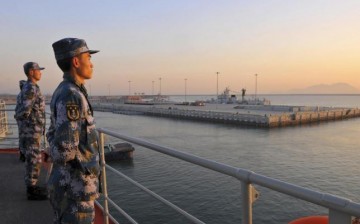 Chinese soldiers stand guard in a naval base across Sanya in Hainan Province.