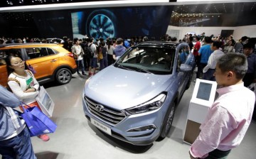 Consumers check the new Hyundai SUV at the 2016 Beijing Auto Show.