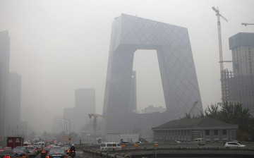  Vehicles move on the street early morning in heavy smog in front of the CCTV headquarters on Nov. 12, 2015 in Beijing, China. 