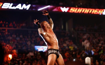 Randy Orton is inside the ring and posing in front of a live crowd.