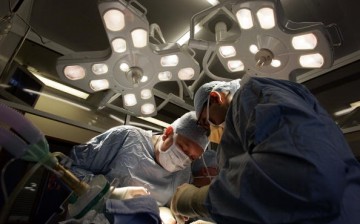 Surgeons operate on a patient for organ transplant.