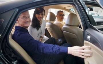 Tim Cook rides a cab with Didi Chuxing President Jean Liu.