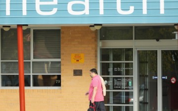 A man walks past a Community Health Centre on May 13, 2014 in Melbourne, Australia.
