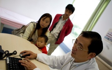 A Chinese doctor evaluates the treatment of a young child who comes into the hospital with his parents.