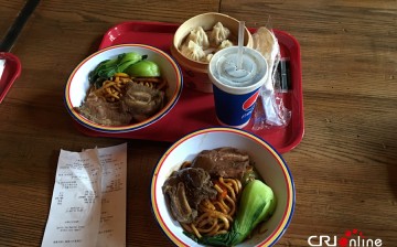 Photo taken on May 20, 2016 shows two bowls of noodles, one cup of coke and one basket of pork buns which cost 180 yuan ($28) at the Shanghai Disney Resort. 