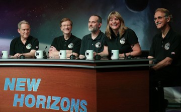 (L-R) Principal investigator Alan Stern, project scientist Hal Weaver, investigator Will Grundy, project scientist Cathy Olkin and imaging team leader John Spencer celebrate after seeing images from the New Horizons spacecraft that passed with 7,800 miles