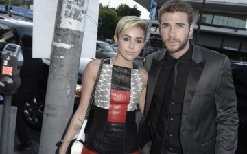 Actress Miley Cyrus and actor Liam Hemsworth attend the premiere of Relativity Media's 'Paranoia' at the DGA Theater on August 8, 2013 in Los Angeles, California.