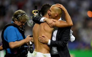 Real Madrid manager Zinedine Zidane (R) hugs star man Cristiano Ronaldo after Champions League win over Atletico Madrid.