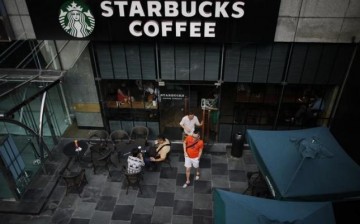 Customers leave a Starbucks retail store in Shanghai.