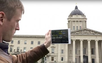 A man uses the Asus ZenPad S 8.0 to take a picture of a building with its different camera features.