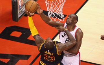 Toronto Raptors center Bismack Biyombo blocks Cleveland Cavaliers' LeBron James.