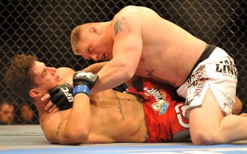 Brock Lesnar holds down Frank Mir during their heavyweight title bout during UFC 100 on July 11, 2009 in Las Vegas, Nevada.