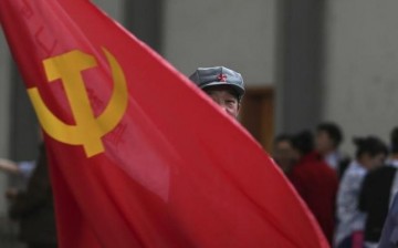 A member of China's Communist Party waves a flag during a gathering in Kunming, Yunnan Province.