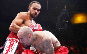 Keith Thurman (L) exchanges blows with Luis Collazo during their WBA Welterweight fight on July 11, 2015 at the USF Sun Dome in Tampa, Florida.