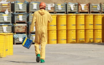  A worker walks by yellow barrels containing potentially radioactive material at the former Rheinsberg nuclear power plant 