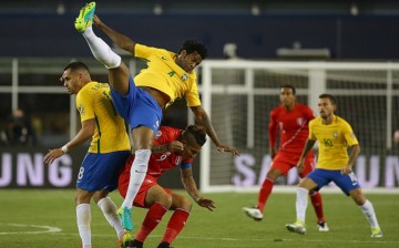 Beijing Guoan's Renato Augusto (L) and Shandong Luneng's Gil suits up for Brazil and competes against Peru's Paolo Guerrero.