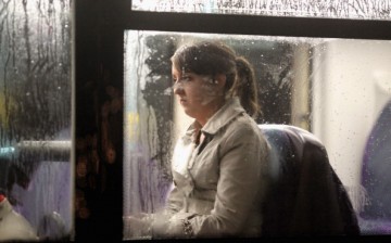A woman looking depressed sits on a bus as it makes its way along St Vincent Street on November 1, 2010 in Glasgow, Scotland.