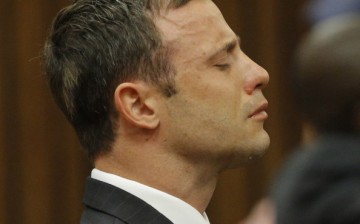 Oscar Pistorius reacts at the Pretoria High Court on September 11, 2014, in Pretoria, South Africa after Judge Thokosile Masipa has ruled out murder charges.