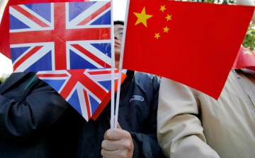 A Chinese man holds British and Chinese flags on Nov. 9, 2005, in London, England. 