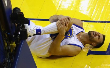 Andrew Bogut #12 of the Golden State Warriors reacts after suffering an apparent injury during the second half against the Cleveland Cavaliers in Game 5 of the 2016 NBA Finals at ORACLE Arena on June 13, 2016 in Oakland, California.