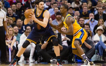 Kevin Love of the Cleveland Cavaliers is posting up Harrison Barnes of the Golden State Warriors during a game.
