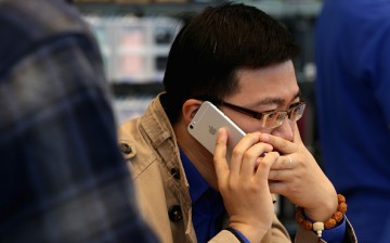 A Chinese man making a call with his iPhone 6 Plus inside an Apple store on Oct. 17, 2014, in Beijing, China.