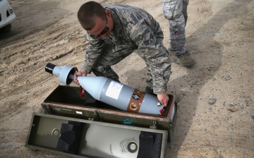 A U.S. Air Force munitions team member uncases the laser-guided tip for a 500 pound bomb to be loaded onto an unmanned aerial vehicle (UAV), for airstrikes on ISIL targets on Jan. 8, 2016 at a base in the Persian Gulf Region. 
