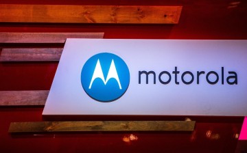 A logo sits illuminated outside the Motorola pavilion during the second day of the Mobile World Congress 2015