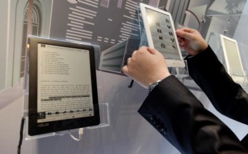 A visitor examines the DR-900 9' Touch E-Reader at the Asus stand at the CeBIT Technology Fair on March 2, 2010 in Hannover, Germany.