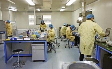 Researchers work at a genomics laboratory in Tianjin.