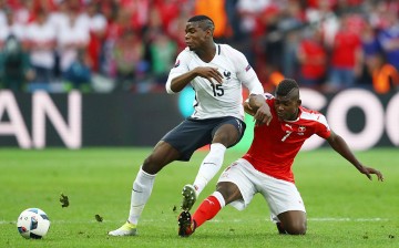 France midfielder Paul Pogba (L) competes for the ball against Switzerland's Breel Embolo.