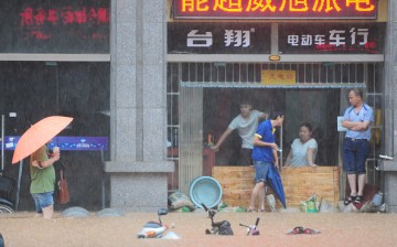 Citizens walk in flood caused by rainstorms on June 15, 2016, in Jiujiang, Jiangxi Province of China.