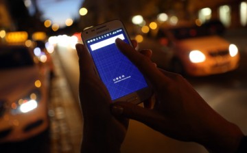 A woman uses the Uber app on a Samsung smartphone on Sept. 2, 2014, in Berlin, Germany.