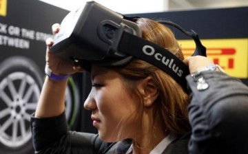 A woman tries a virtual reality (VR) headset at a product show and exhibition.