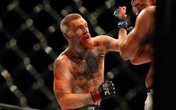 Conor McGregor (L) punches Nate Diaz during UFC 196 at the MGM Grand Garden Arena on March 5, 2016 in Las Vegas, Nevada.