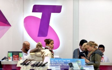 Shoppers in a Telstra retail store in Sydney's CBD browse products on July 24, 2014 in Sydney, Australia. 
