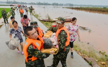 Rescuers evacuate residents from flood-hit areas in Chongqing, China, in this July 2, 2013 photo.