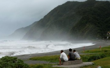 Men watch waves crash at the coast as Typhoon Nepartak approaches in Yilan, Taiwan, July 7, 2016.