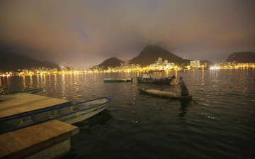 A fisherman paddles in the polluted Rodrigo de Freitas Lagoon, venue for the rowing events at the Rio 2016 Olympic Games, on July 1, 2016 in Rio de Janeiro, Brazil. 