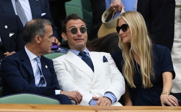 Mark Cairney, Jude Law and Phillipa Coan watch on as Switzerland's Roger Federer plays Canada's Milos Raonic at the Wimbledon Championships 2016 in London, England. 