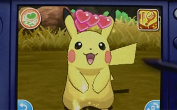 Pokemon Pikachu is being petted by its owner in 